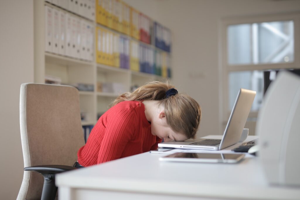 sulking woman on laptop looking stressed
